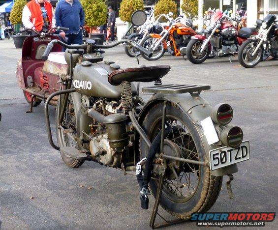 Olive drab military motorcycle with sidecar, rear view. License plate reads 5OTZD
