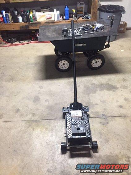 Hydraulic floor jack in front of a Groundwork utility cart in a garage