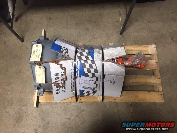 Gray transmission and boxed parts on a wooden pallet