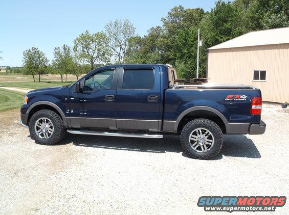 Dark blue 2005 Ford F-150 FX4 Off Road pickup truck, side view