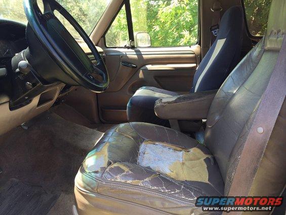 Interior shot of a worn SUV, showing ripped seats and dashboard