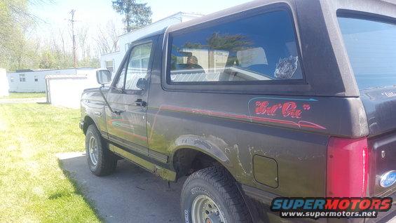 Side view of a 1991 Ford Bronco with 'Lil Bit' decal on the rear quarter panel