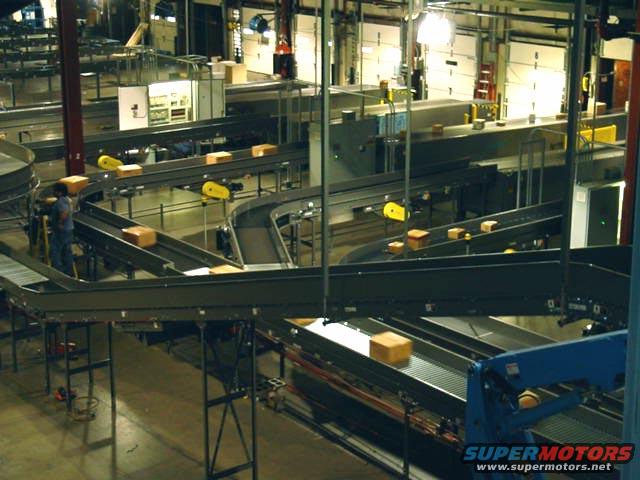 Packages moving on conveyor belts in a warehouse