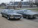 1985 Ford Crown Victoria LTD - Two Ford Crown Victorias are parked side-by-side on a street in front of a building.