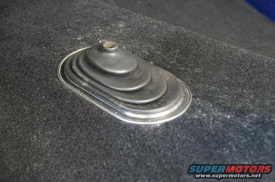 Carpeted floor with a chrome-trimmed rubber shifter boot