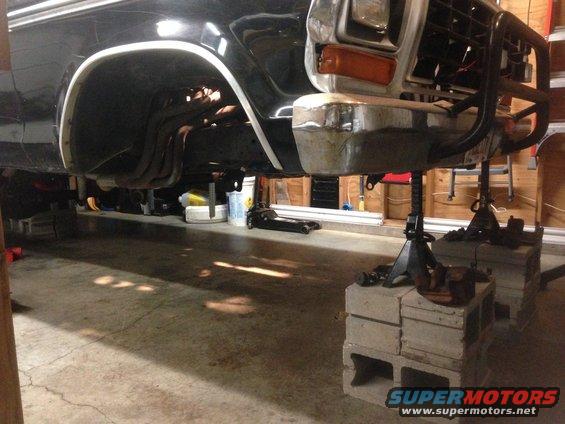 1979 Ford Bronco front end on jack stands, showing suspension and front bumper