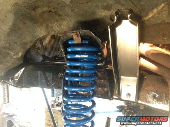 Blue coil spring suspension part with visible text 'JBA HORSEPOWER'