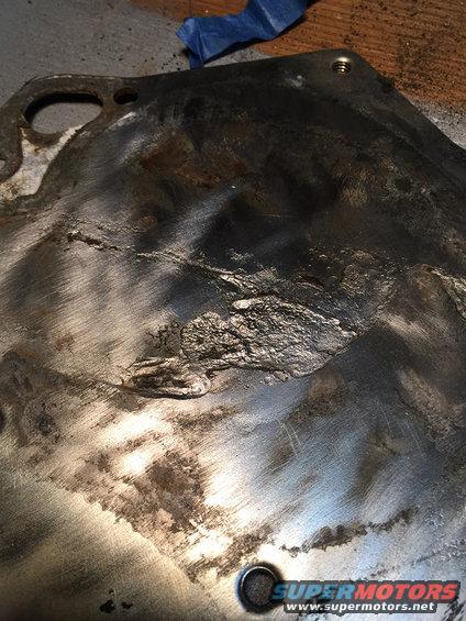 Damaged metal part with rough texture and scratches