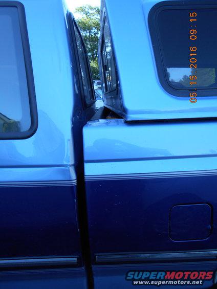 Blue pickup truck side view, showing two-tone paint and a camper shell