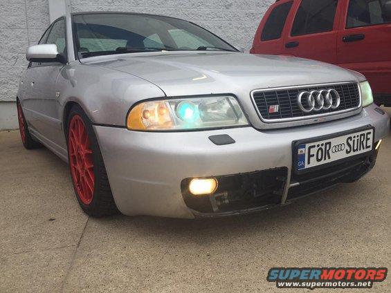 Silver 2001 Audi S4 sedan with red wheels, front view, showing custom license plate and aftermarket front bumper