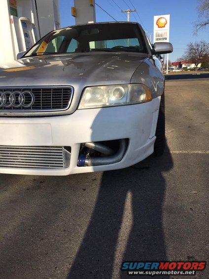 Silver Audi S4 with a white primer front bumper, showing the intercooler and piping. Parked at a gas station