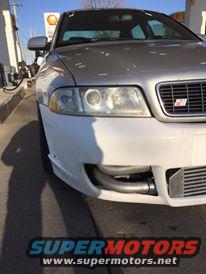 Silver 2001 Audi S4 front bumper with intercooler visible, at a gas station