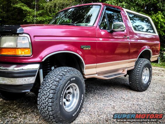 Red 1995 Ford Bronco 3/4 front view with off-road tires