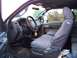 2011 Ford F-250 - The interior of a truck is shown, seat covers and a steering wheel cover.