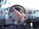 2011 Ford F-250 - The interior of a 2011 Ford F-250 is visible, focusing on the steering wheel and dashboard controls.