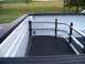 2011 Ford F-250 - The interior of a truck bed is shown with metal cargo bars. A distant landscape is visible beyond the truck.