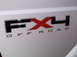 2011 Ford F-250 - Close-up of the FX4 Off Road badging on a white Ford truck.