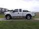 2011 Ford F-250 - Side view of a white 2011 Ford F-250 pickup truck parked outside a house.