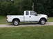 2011 Ford F-250 - This white 2011 Ford F-250 Super Duty pickup truck is shown from the side.