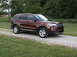 2016 Ford Explorer - This 2016 Ford Explorer is parked on a gravel driveway with grass and trees in the background.