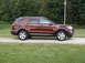 2016 Ford Explorer - 2016 Ford Explorer parked on gravel with trees in the background.