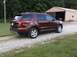 2016 Ford Explorer - A maroon Ford Explorer is parked on a gravel driveway next to a barn.