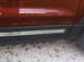 2016 Ford Explorer - The side panel of a red SUV features black trim with the 'EXPLORER' nameplate.