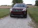 2016 Ford Explorer - A maroon 2016 Ford Explorer is parked on a gravel driveway with a field in the background.
