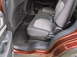 2016 Ford Explorer - Interior view of the back seats and door panel of an orange SUV.