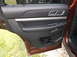 2016 Ford Explorer - The interior door panel of a brown SUV features black leather trim and chrome accents, with a Supermotors.net watermark at the bottom.