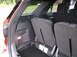 2016 Ford Explorer - The interior cargo space of an SUV, folded rear seats and a visible 'SUPERMOTORS' watermark.