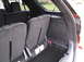 2016 Ford Explorer - The rear interior of an SUV shows folded seats and a spare tire, with no visible year-identifying features.