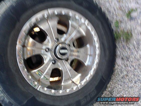 Chrome aftermarket wheel with a black tire. The wheel has a multi-spoke design with polished accents