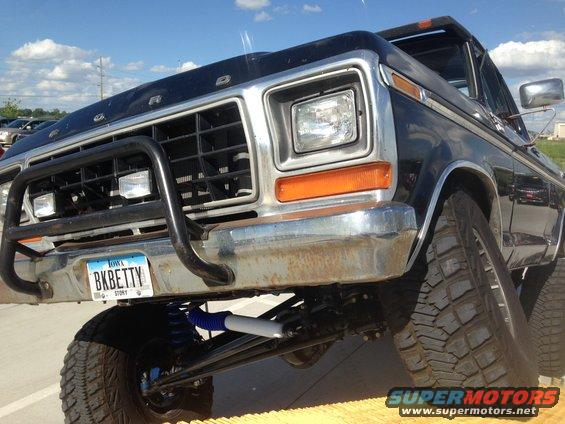 Front view of a black 1979 Ford Bronco with a bull bar and custom suspension