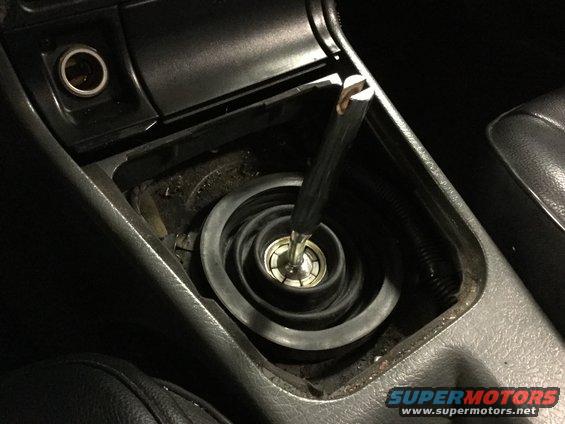 Close-up of a car's manual gear shifter with the rubber boot visible