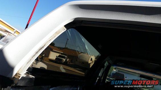 Reflection of white pickup truck in window