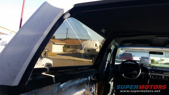 Interior of a 1992 Ford Bronco showing the dashboard, steering wheel, and open driver's side window