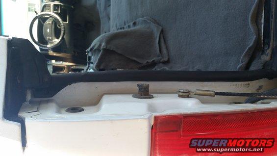 Rear interior of white SUV, showing trim and weatherstripping