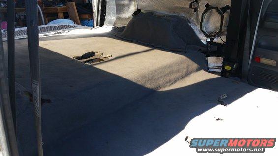 Interior of vehicle with torn carpet and exposed floor
