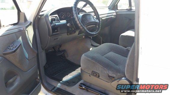 1992 Ford Bronco interior showing gray fabric seats, dashboard with gauges, and steering wheel