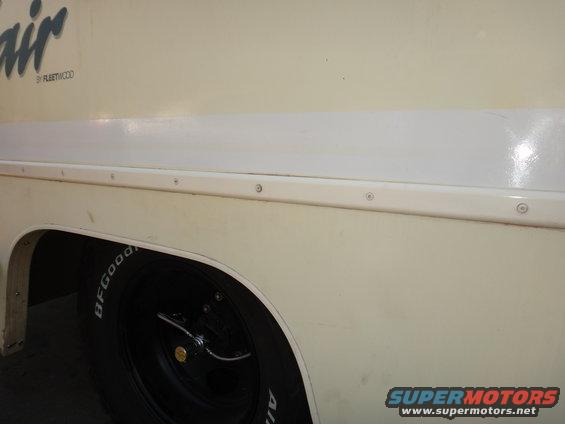 Cream step van side view with white stripe and BFGoodrich tire
