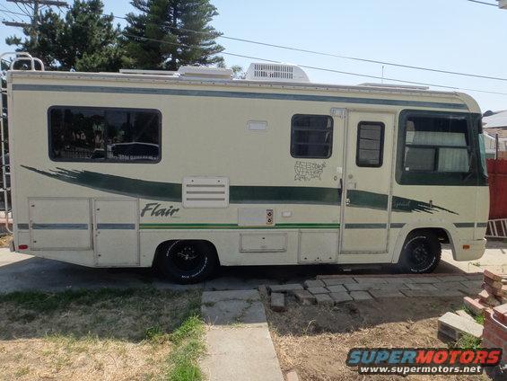 Class C RV parked outdoors, side view