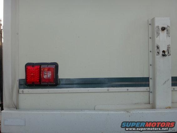 Step van rear corner with dual red tail lights and a white vertical support post