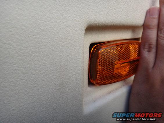 Orange side marker light on textured interior panel