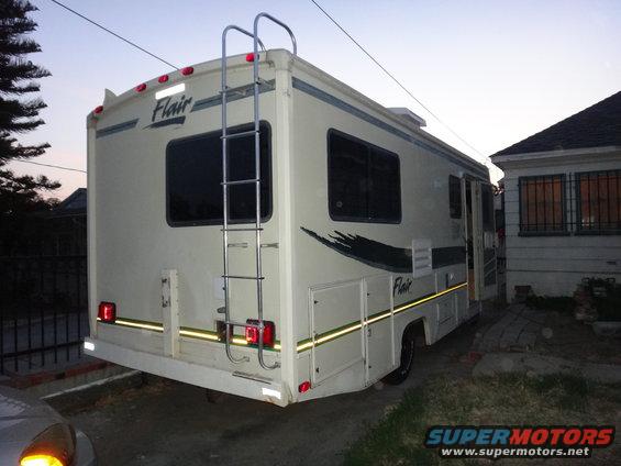 Rear view of a Flair RV motorhome with a ladder on the back
