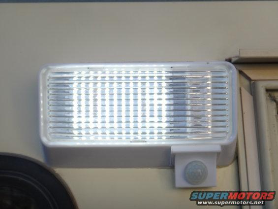 Rectangular exterior RV light with a motion sensor attached to the housing