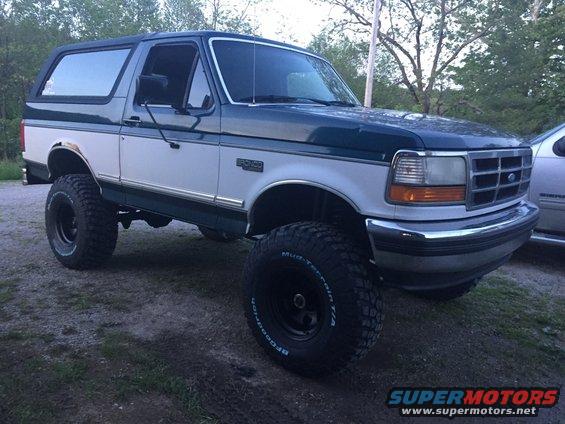 Lifted 1994 Ford Bronco, two-tone green and white, with large off-road tires