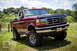 1995 Ford Bronco - This 1995 Ford Bronco is shown in a three-quarter front view, off-road tires and a classic Ford emblem on the grille.