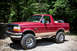 1995 Ford Bronco - This red 1995 Ford Bronco features tan two-tone trim and a spare tire mounted in the cargo area.