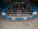 1967 Ford Mustang - The front of a blue 1967 Ford Mustang is shown with its hood open, revealing the engine bay.